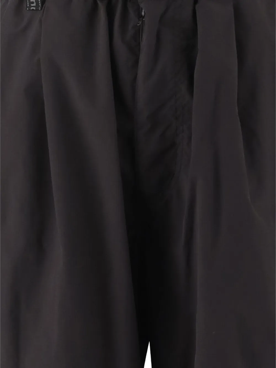 Close up of black pants, showing the fabric of sythenic material