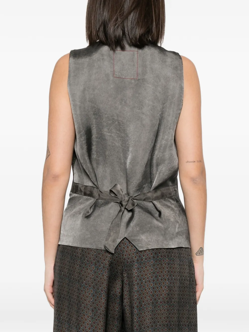 Tan coats worn by a person, showing the coats fit