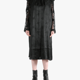 Black coats worn by a person, showing the coat's fit