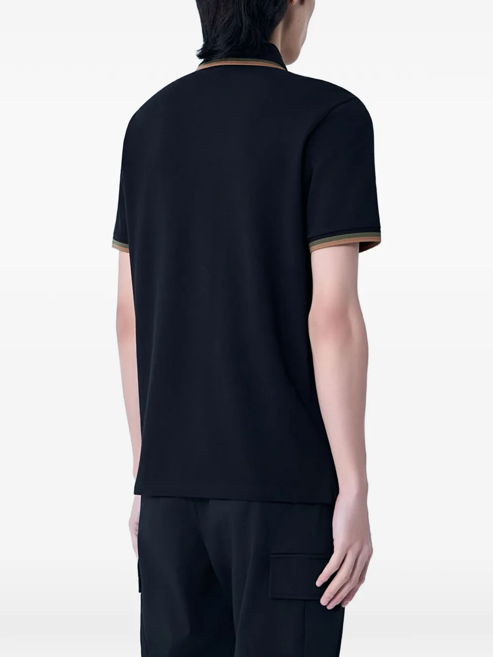 black shirts worn by a person, showing the shirts  fit