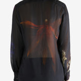 Black shirt worn by a person, showing the shirt's fit