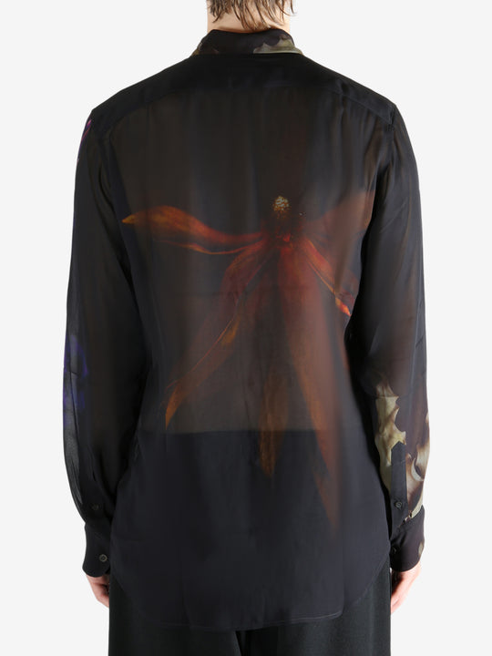 Black shirt worn by a person, showing the shirt's fit