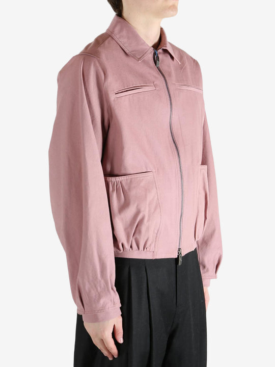 Pink jacket worn by a person, showing the jacket fit