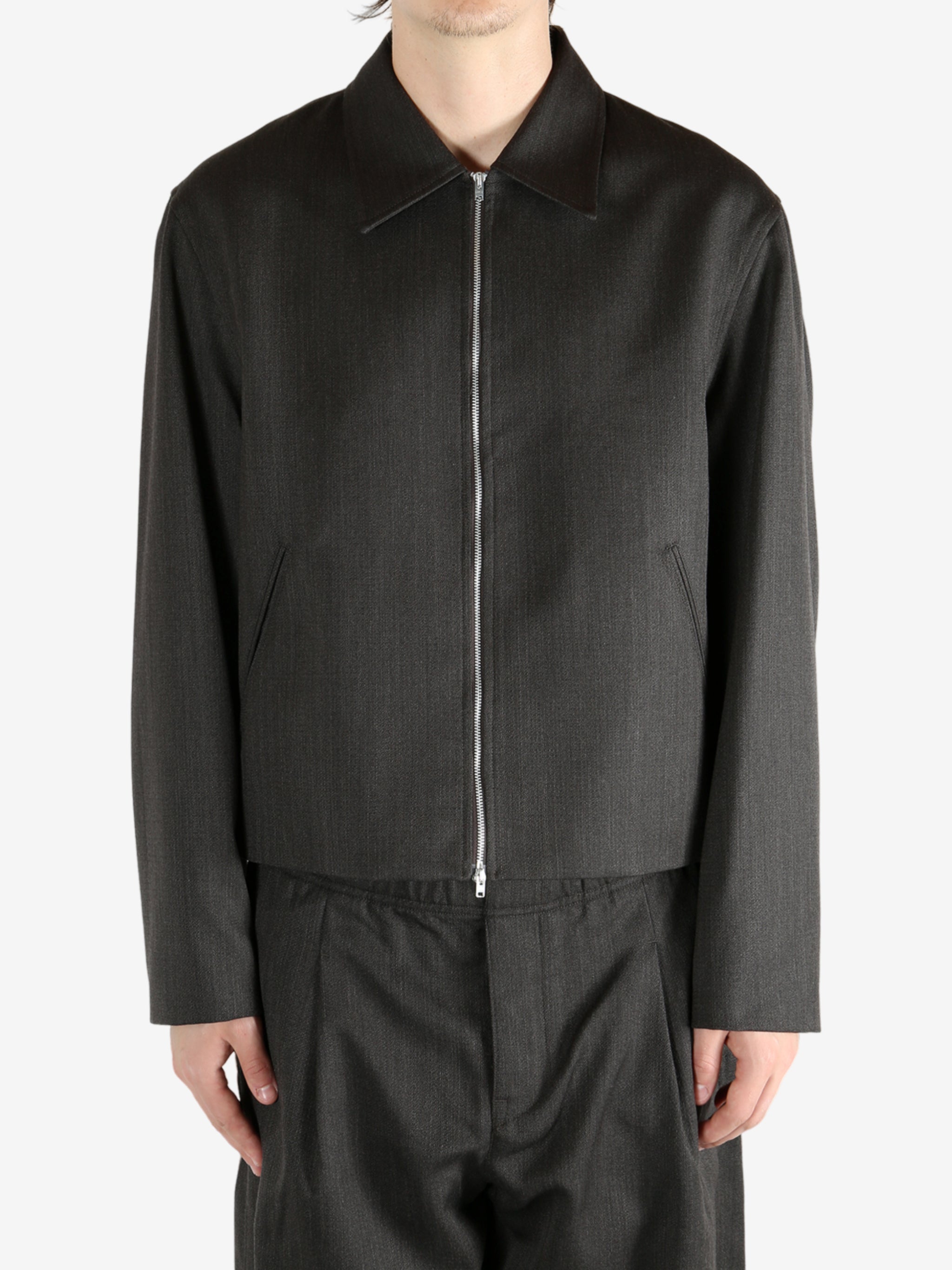 Brown jacket worn by a person, showing the jacket's fit