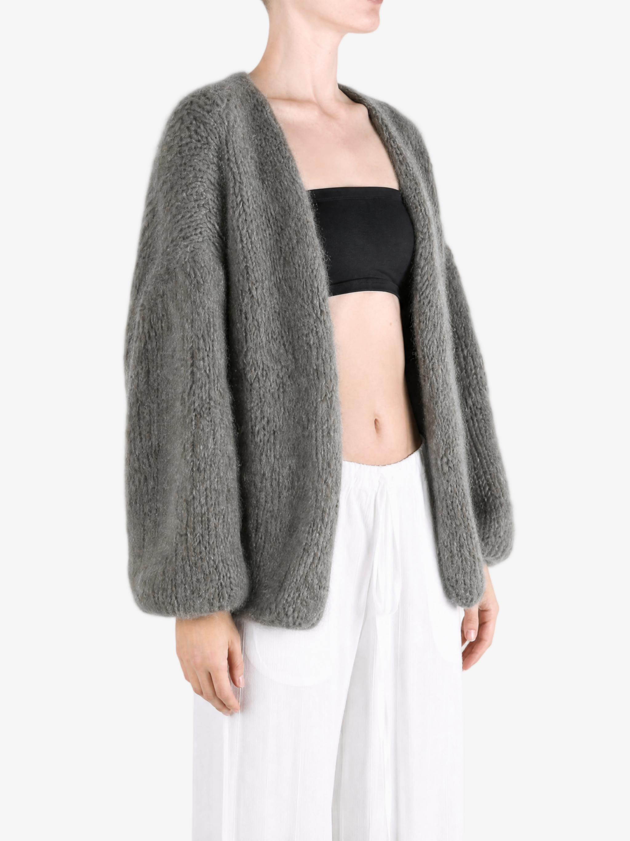 Grey knitwear worn by a person, showing the knitwear fit