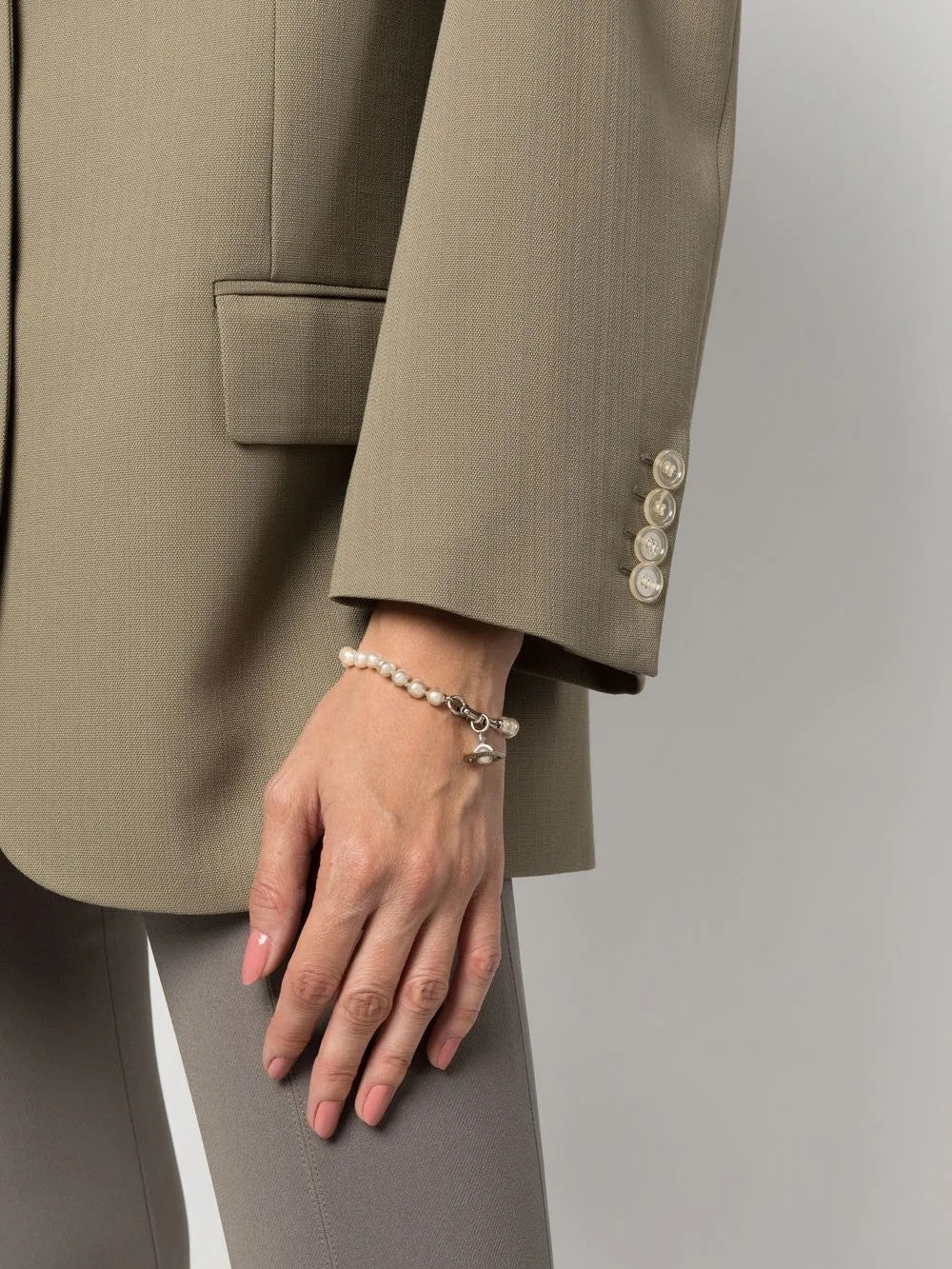 White jewelry worn by a person, showing the jewelry fit