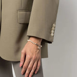 White jewelry worn by a person, showing the jewelry fit