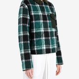 Green jacket worn by a person, showing the jacket fit