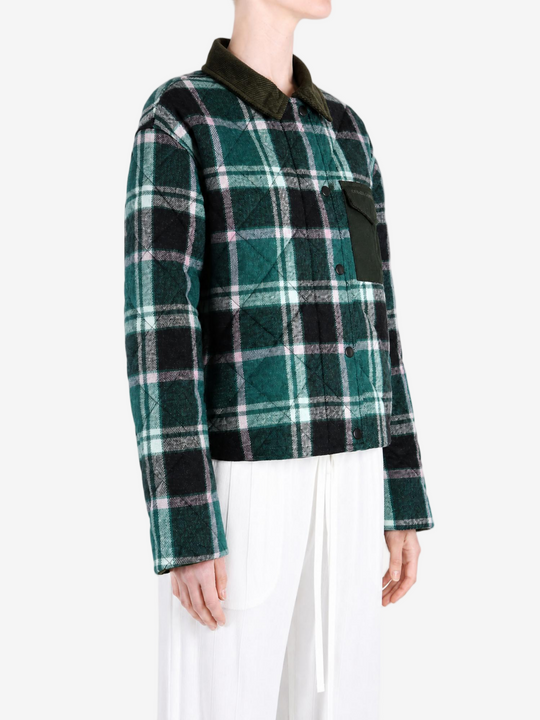 Green jacket worn by a person, showing the jacket fit