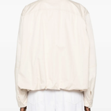 White jackets-coats worn by a person, showing the jackets-coats's fit