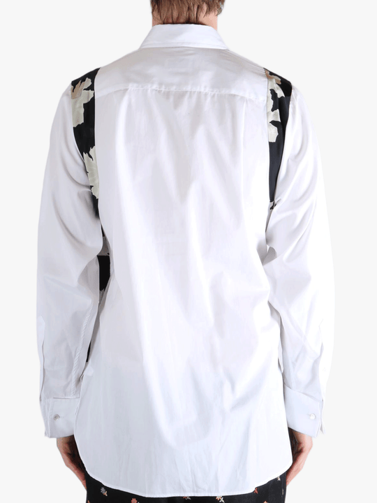 White shirt worn by a person, showing the shirt's fit