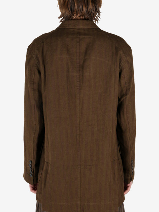 Brown jacket worn by a person, showing the jacket's fit