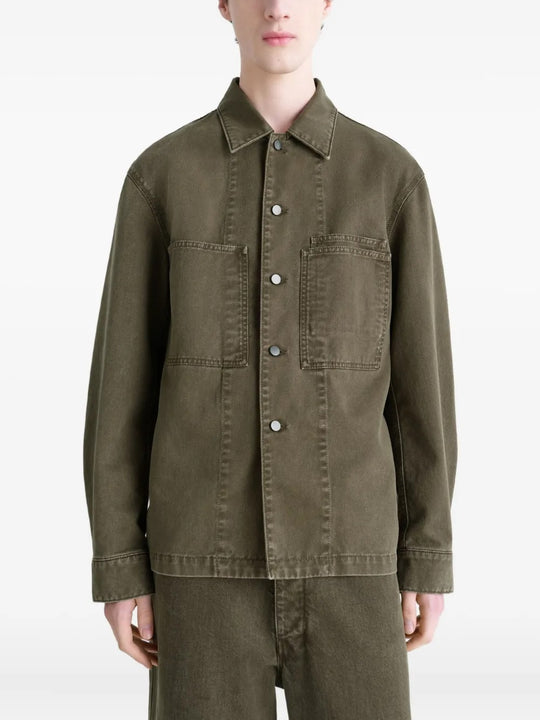 Green shirt worn by a person, showing the shirt's fit