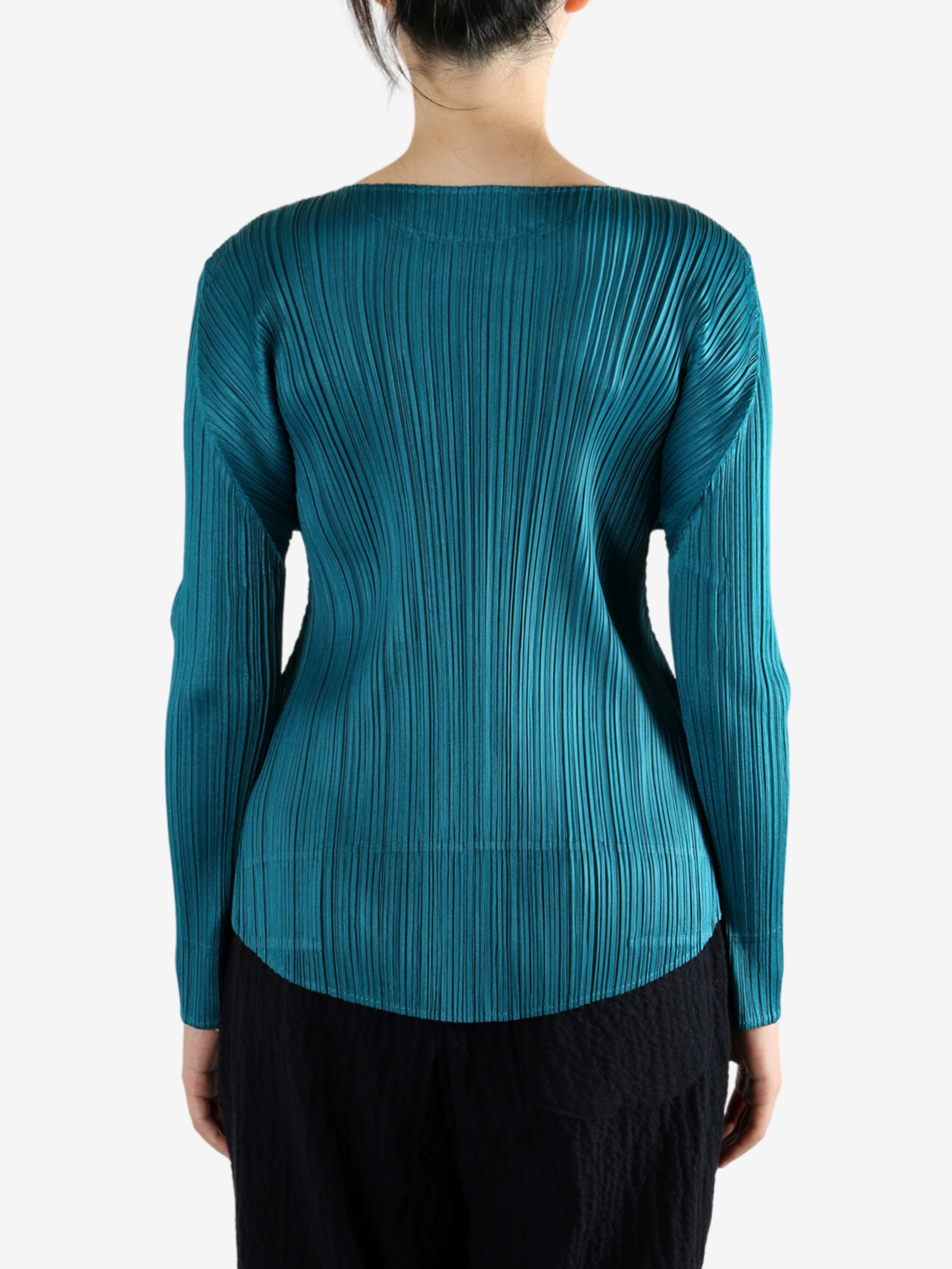 Green top worn by a person, showing the top fit