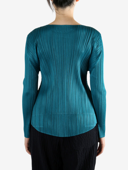 Green top worn by a person, showing the top fit