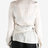 Tan shirt worn by a person, showing the shirt's fit