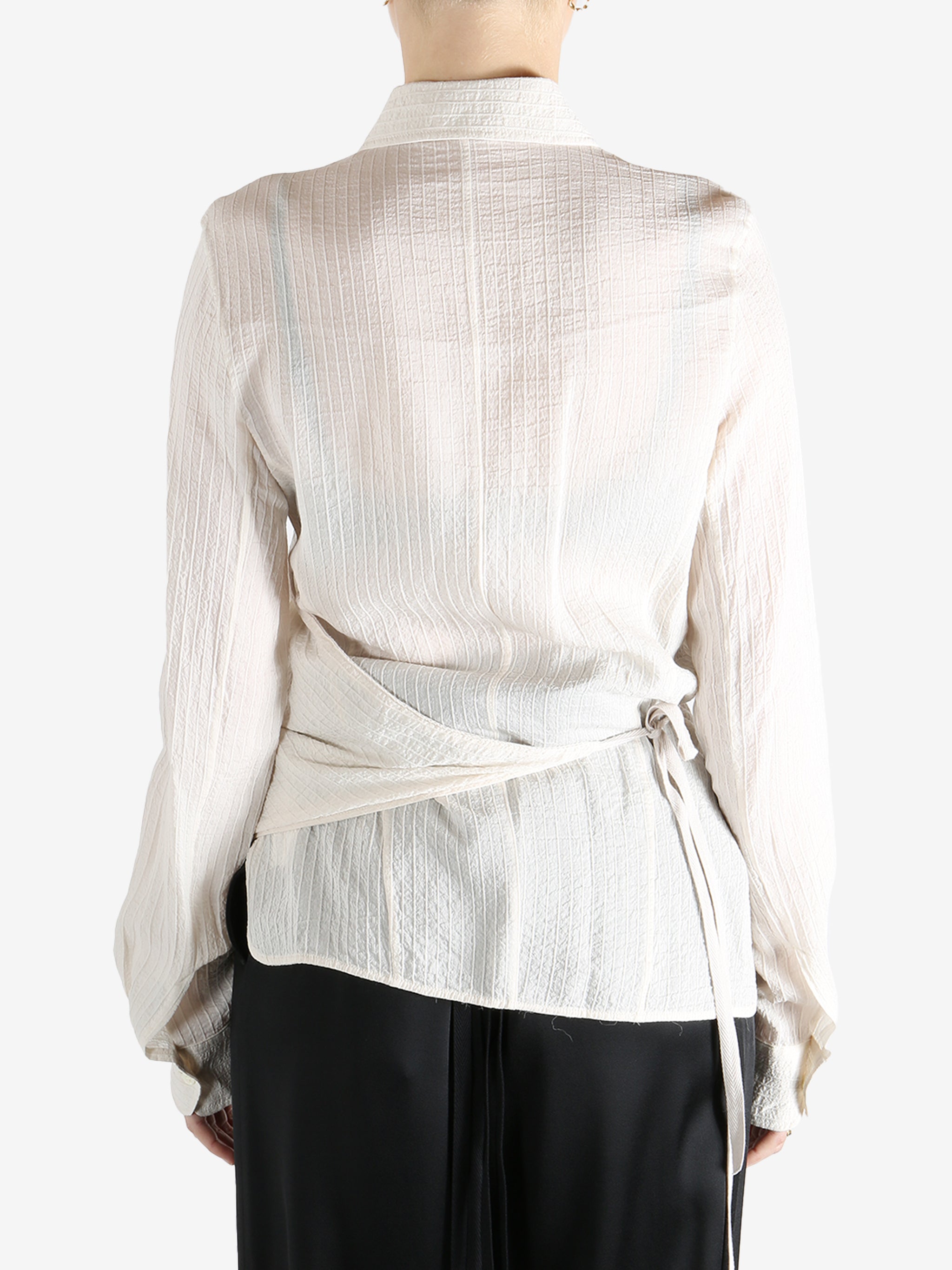 Tan shirt worn by a person, showing the shirt's fit