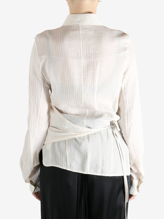 Tan shirt worn by a person, showing the shirt's fit