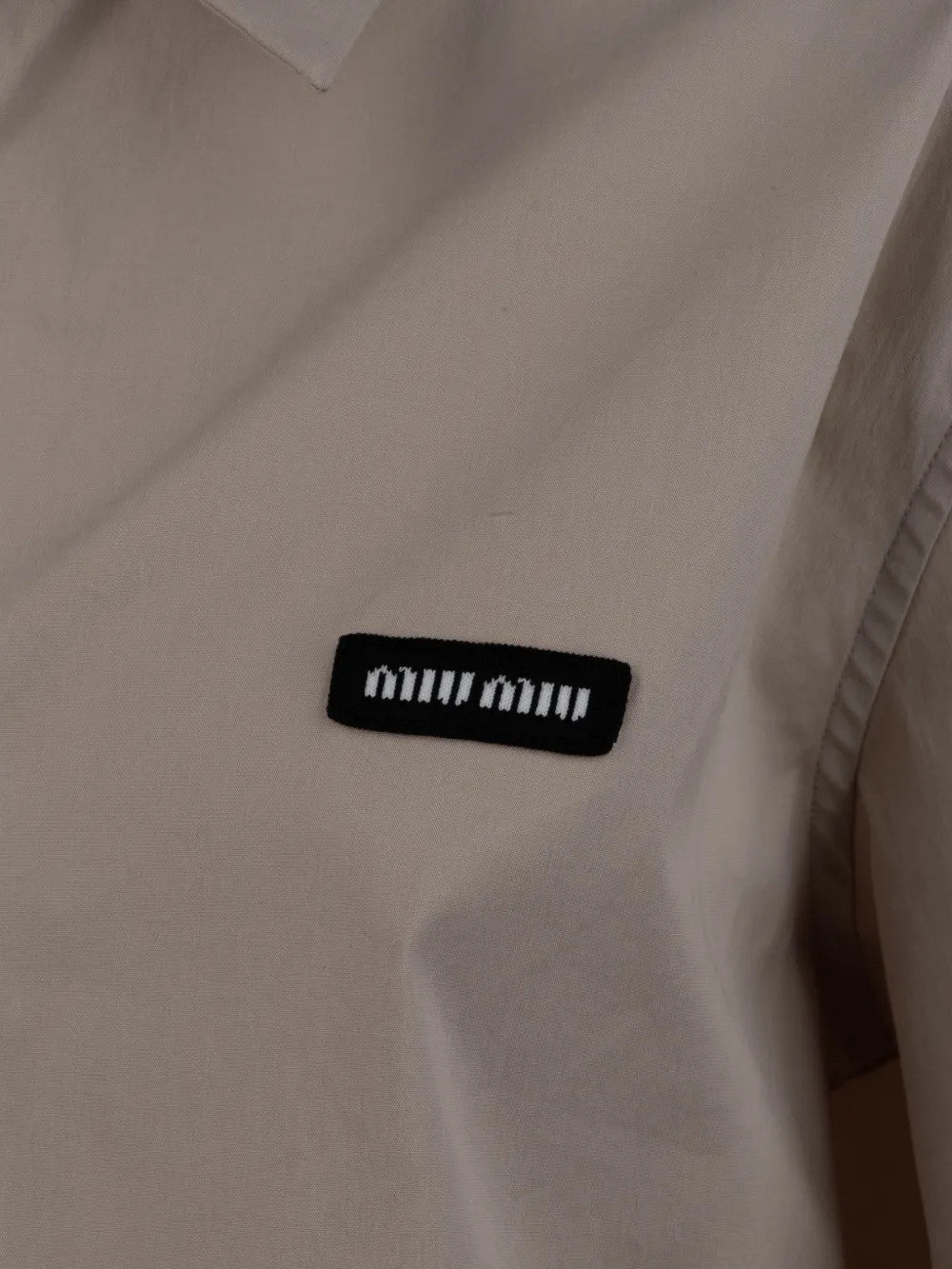 Close up of Tan shirt, showing texture of the 76% cotton/ 20% polyamide/ 4% elastane fabric