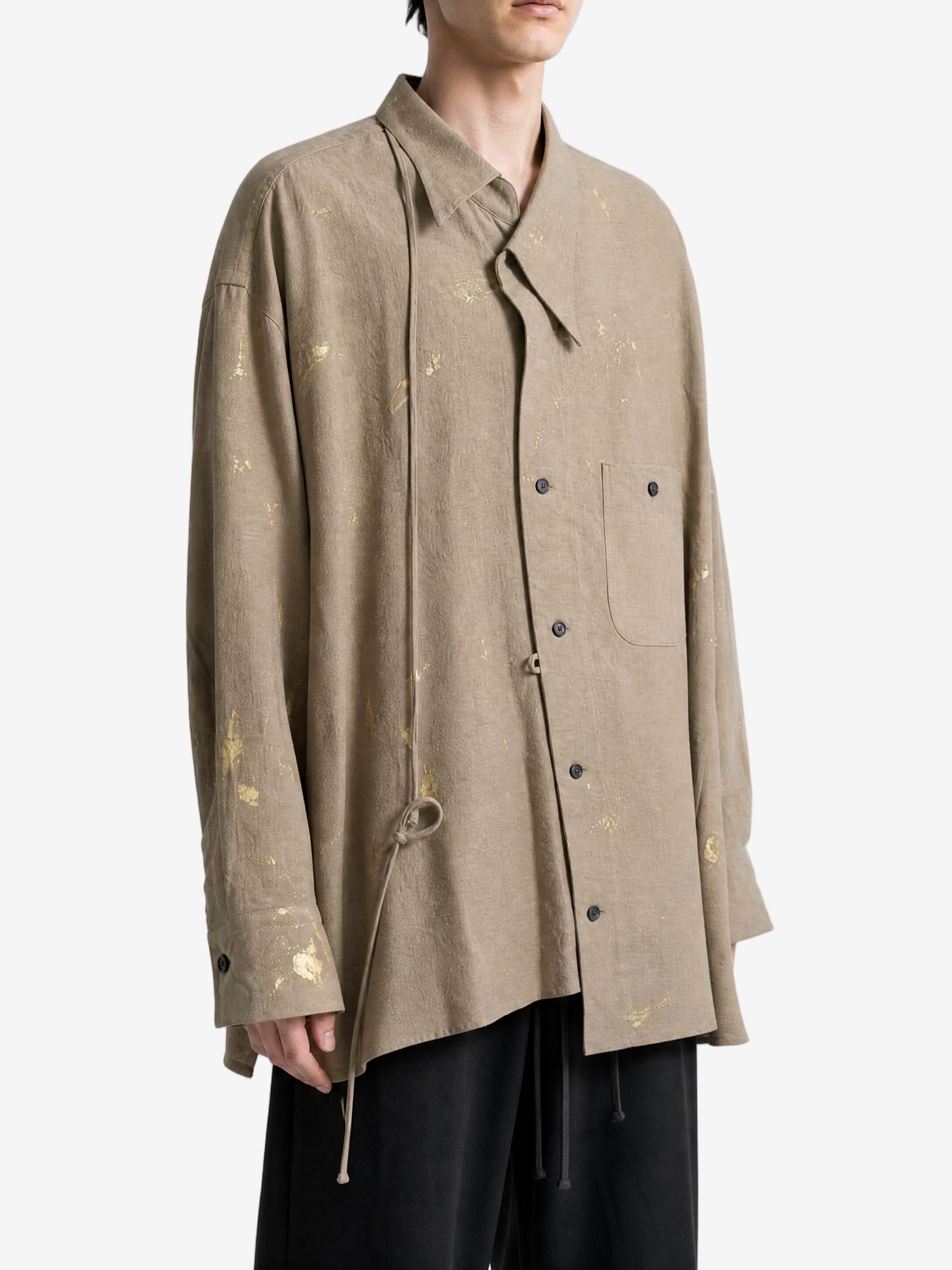 Tan shirt worn by a person, showing the shirt fit