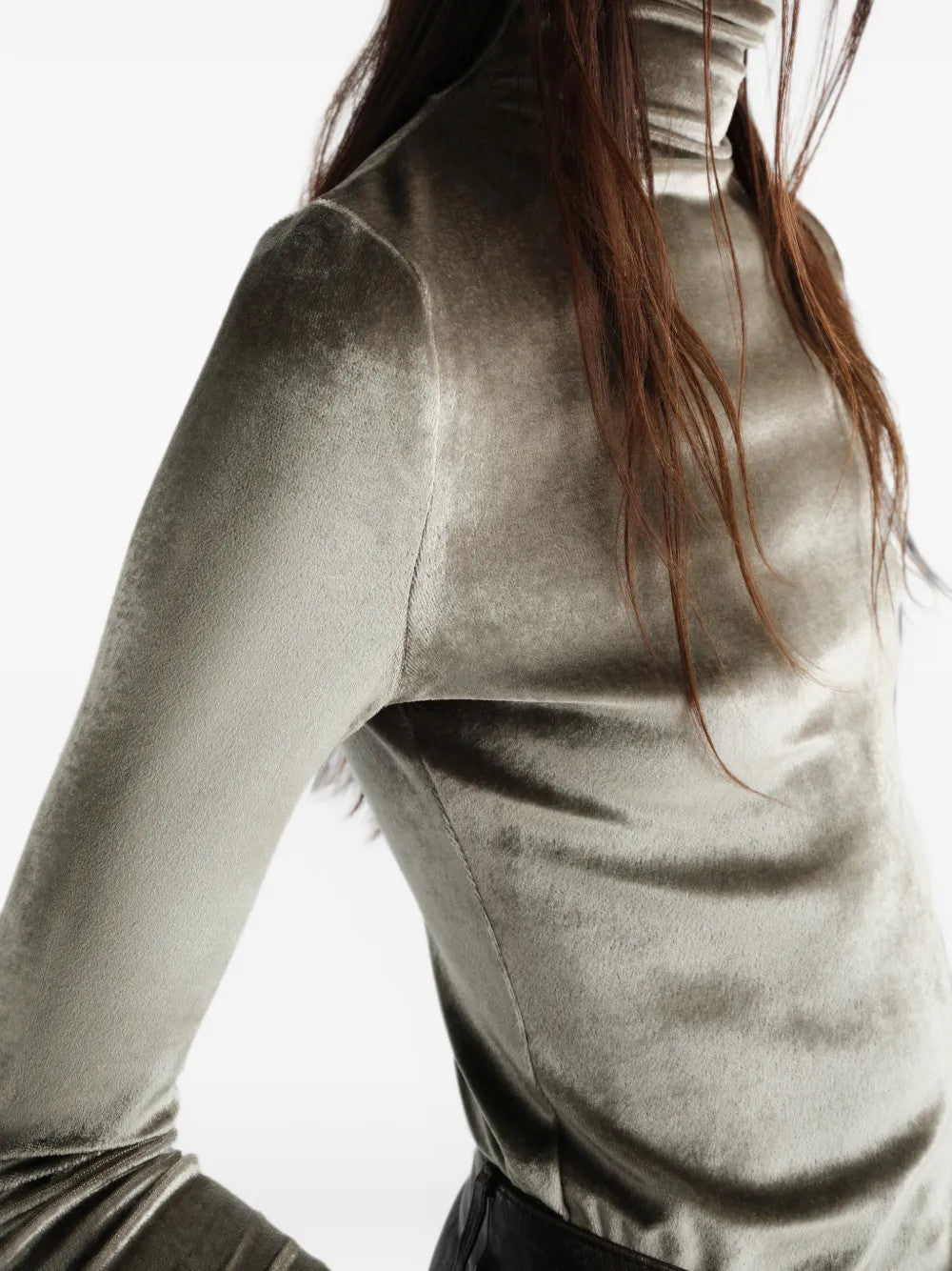 Green top worn by a person, showing the top fit
