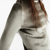 Green top worn by a person, showing the top fit