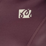 Close up of Burgundy jacket, showing texture of the 66% recycled polyester/ 34% elastane made in fabric