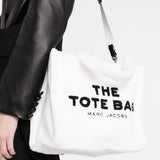 White bag carried by a person, showing the bag's fit