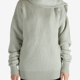 Green knitwear worn by a person, showing the knitwear fit