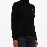 Black knitwear worn by a person, showing the knitwear fit