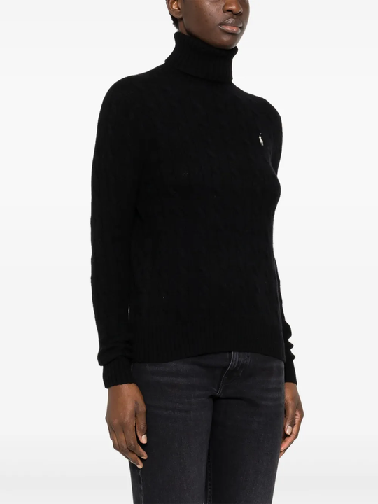 Black knitwear worn by a person, showing the knitwear fit