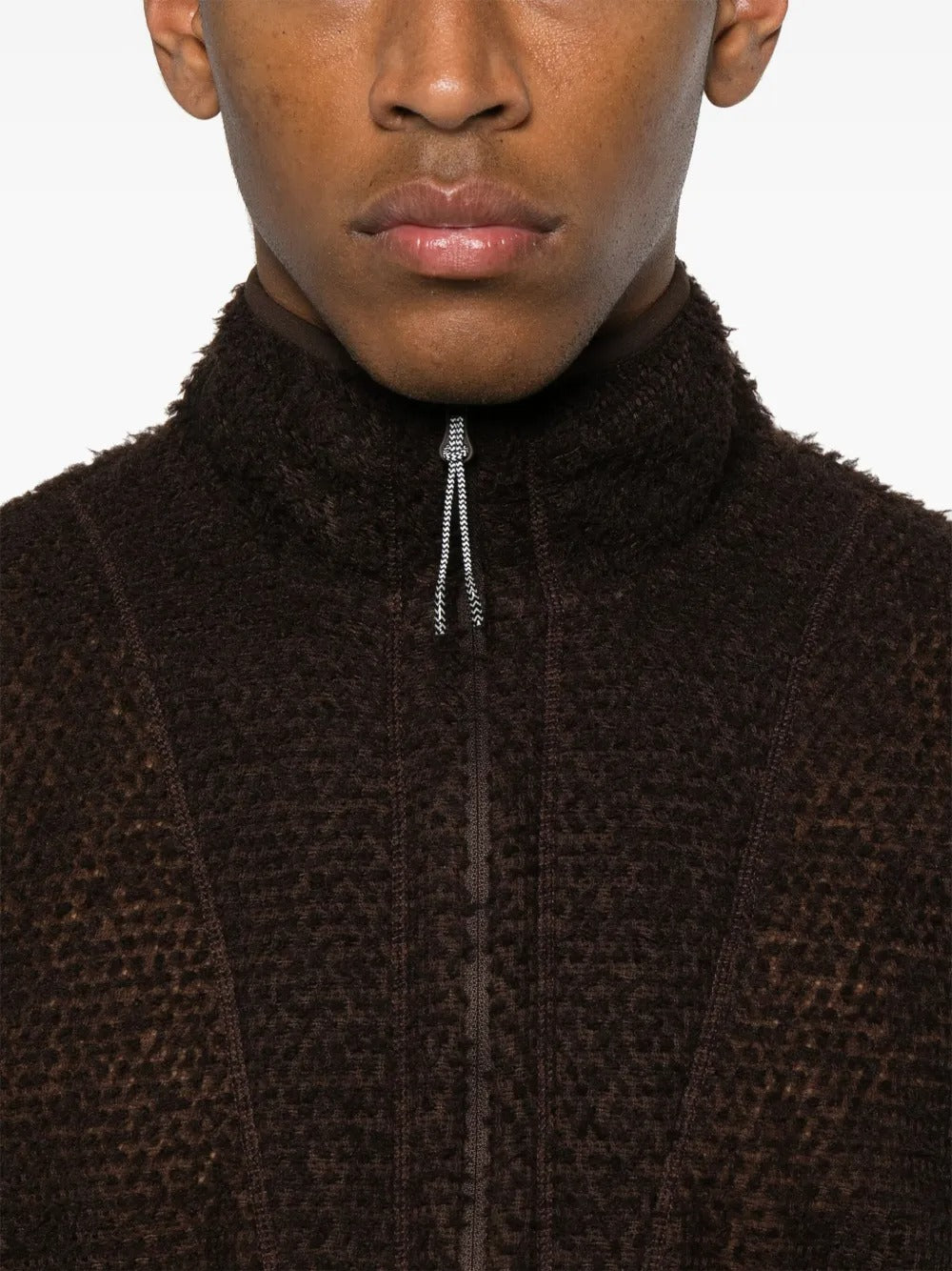 Close up of the brown knitwear, showing texture of the polyester fabric