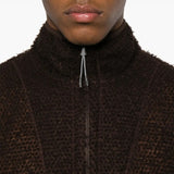 Close up of the brown knitwear, showing texture of the polyester fabric