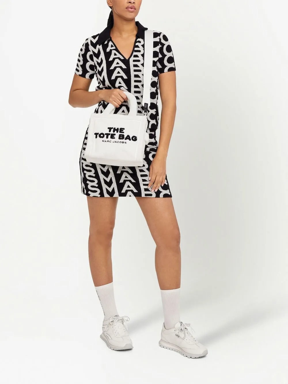 White bag carried by a person, showing the bag's fit