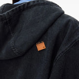 Close up of black hoodie, showing texture of the cotton fabric
