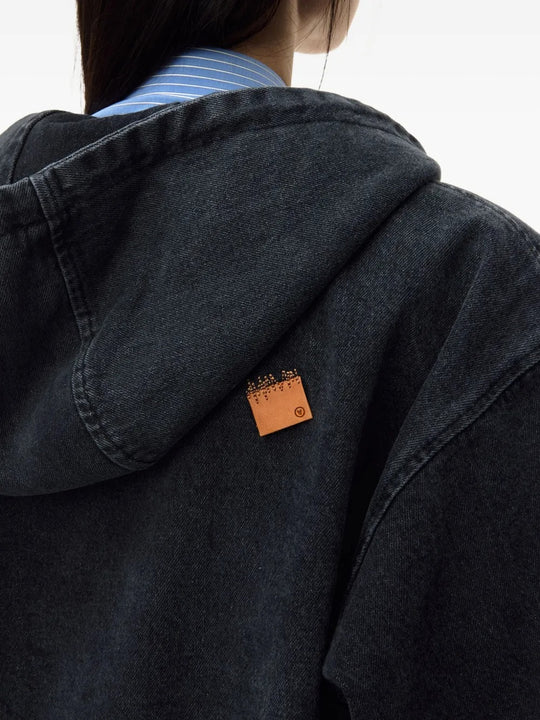 Close up of black hoodie, showing texture of the cotton fabric