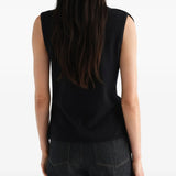 Black top worn by a person, showing the top fit