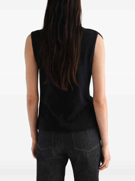 Black top worn by a person, showing the top fit
