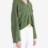 Green knitwear worn by a person, showing the knitwear fit
