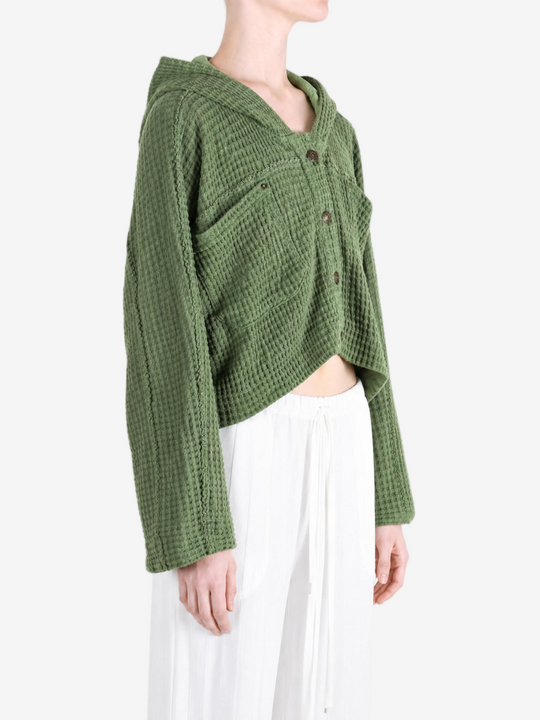Green knitwear worn by a person, showing the knitwear fit