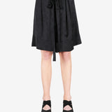 Black pant worn by a person, showing the shirt fit