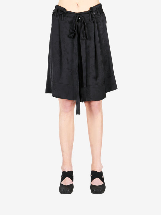 Black pant worn by a person, showing the shirt fit