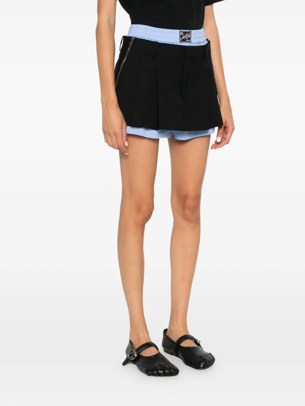 Black shorts worn by a person, showing the shorts's fit
