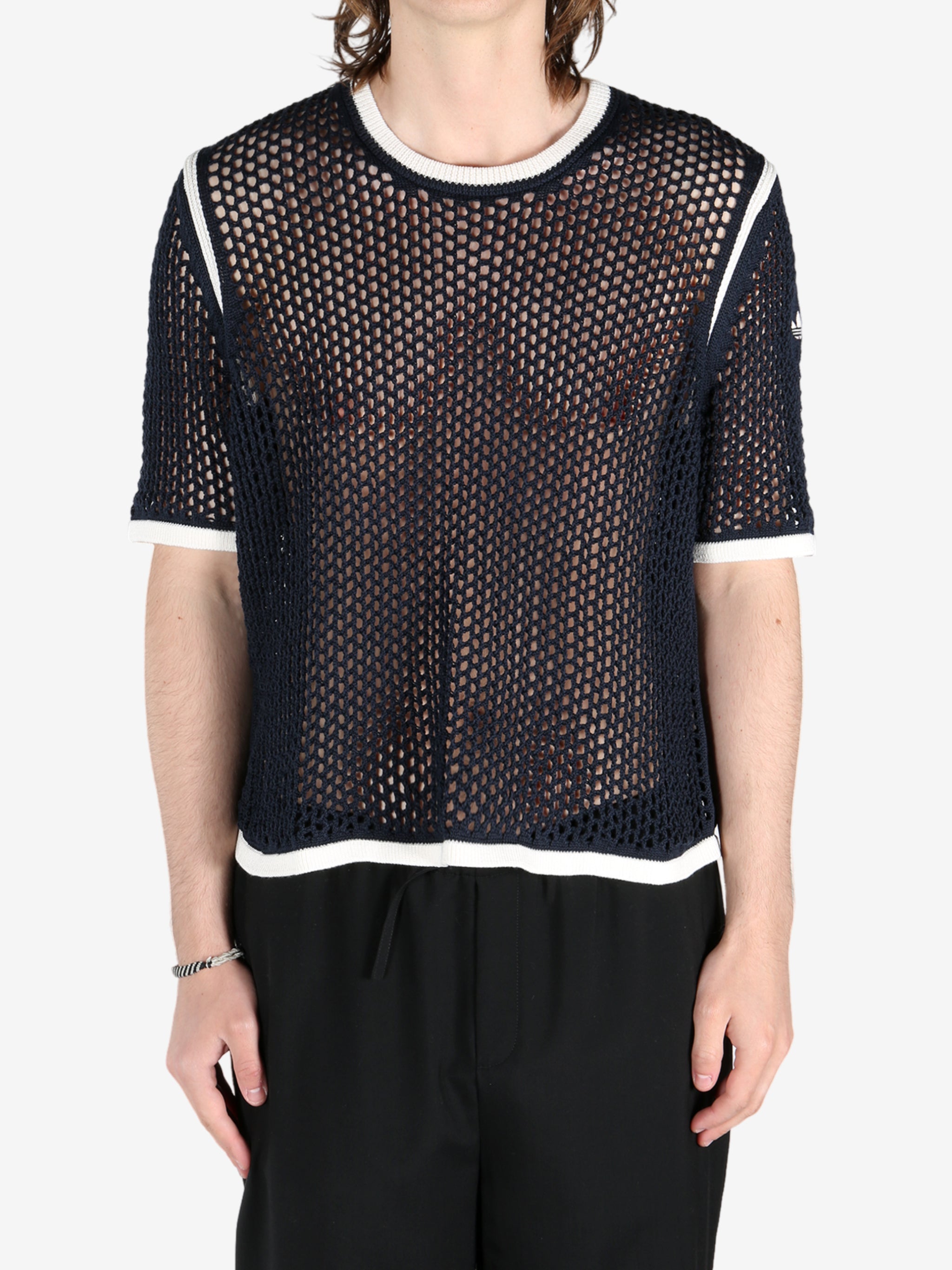 Black shirts worn by a person, showing the shirts fit