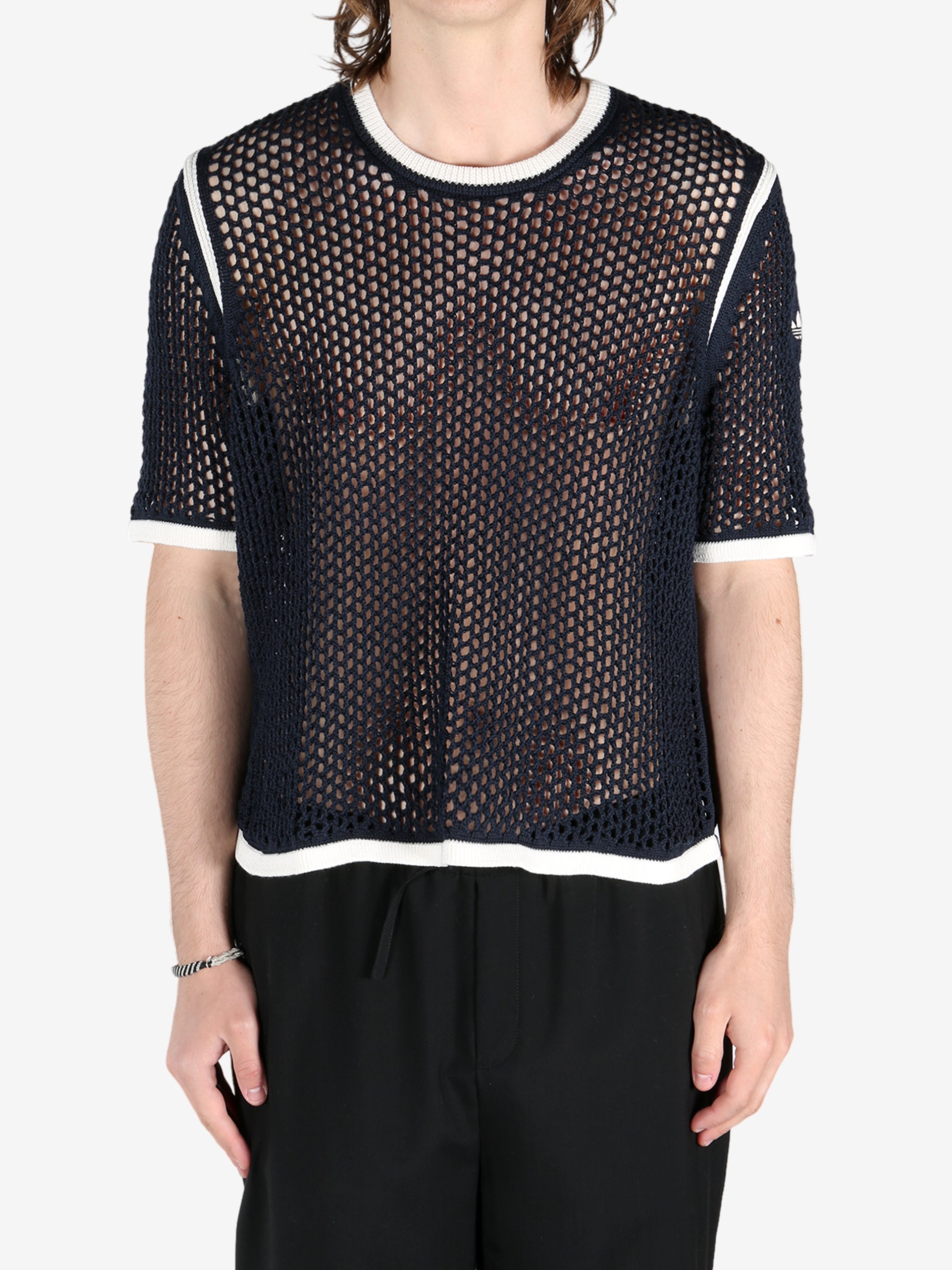 Black shirts worn by a person, showing the shirts fit