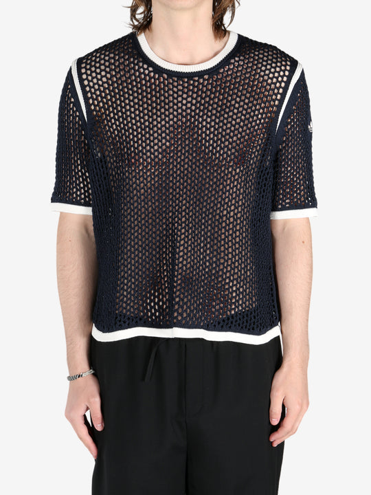 Black shirts worn by a person, showing the shirts fit