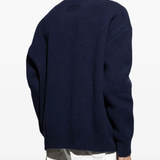 Blue sweater worn by a person, showing the sweater's fit