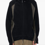 Black jackets worn by a person, showing the jackets fit