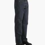 Black jeans worn by a person, showing the jeans fit
