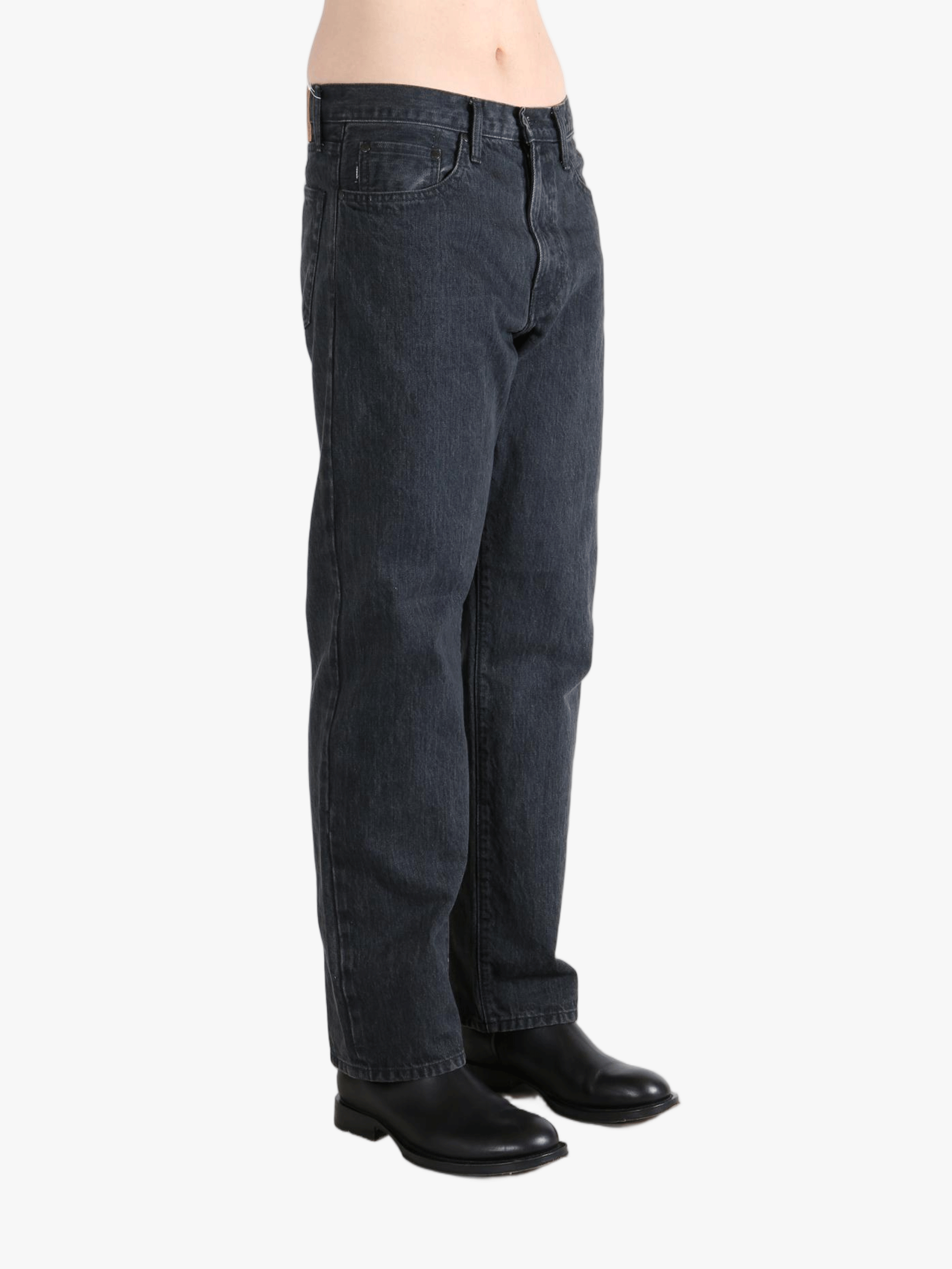 Black jeans worn by a person, showing the jeans fit